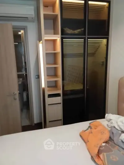 Modern bedroom with built-in wardrobe and air conditioning unit
