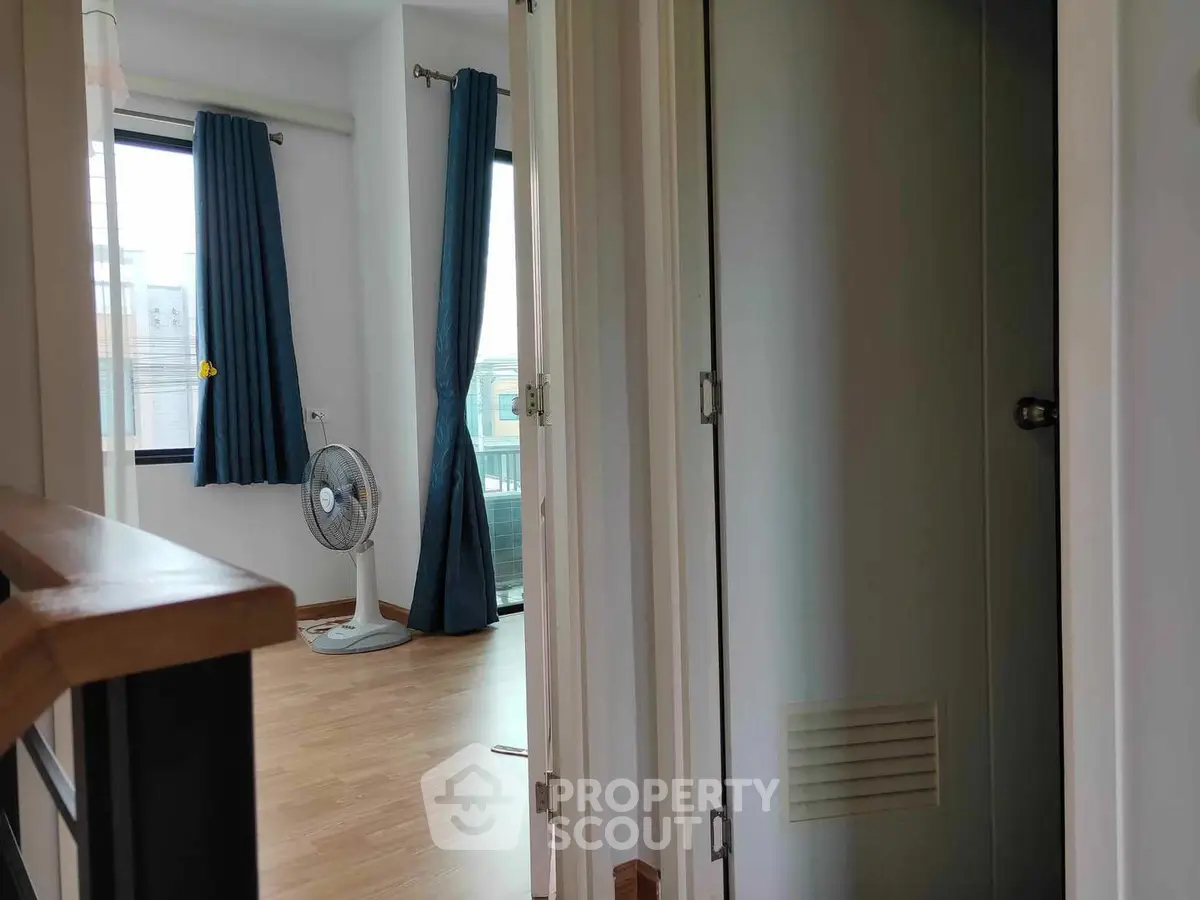 Bright and airy corner unit with a spacious living room leading to a large balcony, featuring modern flooring and elegant curtains.