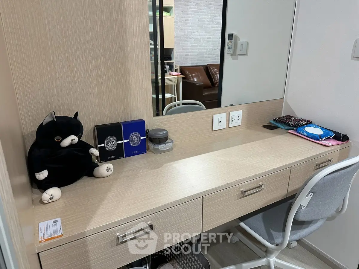 Modern study area with sleek desk and comfortable chair in stylish apartment.