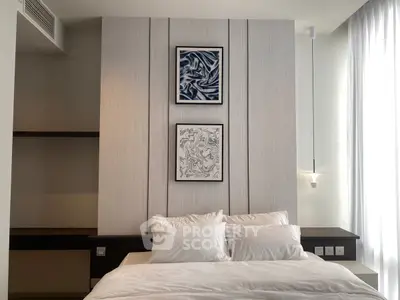 Modern bedroom with stylish decor and cozy ambiance, featuring elegant wall art and soft lighting.