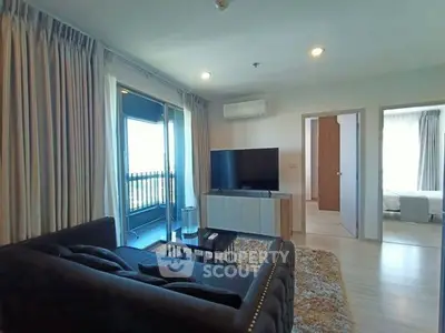 Spacious modern living room with balcony access and stylish decor