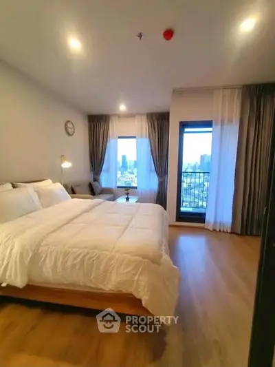 Spacious bedroom with city view and modern decor in luxury apartment