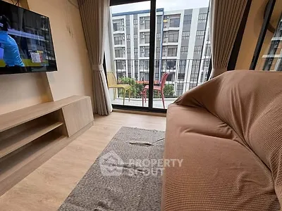 Cozy living room with balcony view in modern apartment