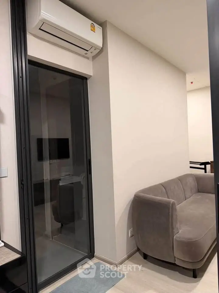 Modern living room with sleek air conditioning and stylish gray sofa, perfect for urban living.