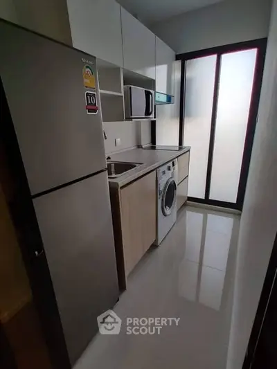 Modern compact kitchen with sleek appliances and ample storage space