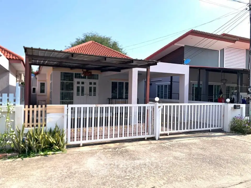 Charming suburban home with gated driveway and modern exterior design.