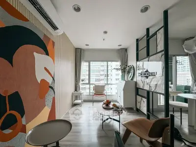 Modern living room with stylish decor and large windows in a high-rise apartment.
