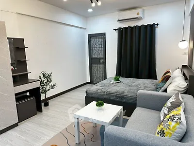Modern studio apartment with cozy living area and stylish decor