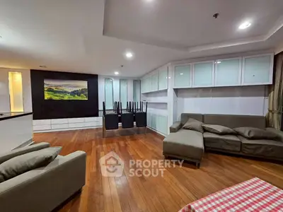 Spacious living room with hardwood floors and modern furniture