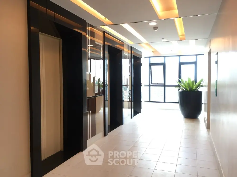 Modern building hallway with sleek elevators and natural light