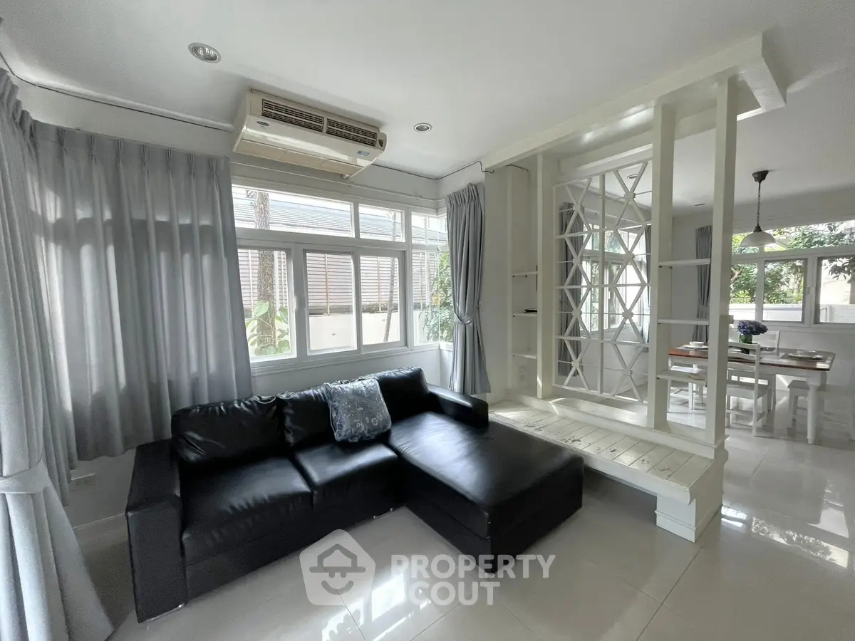 Spacious living room with modern decor and large windows in a stylish home