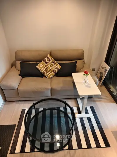 Cozy living room with modern sofa and stylish glass coffee table