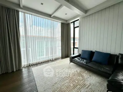 Spacious living room with modern design and large windows for natural light.