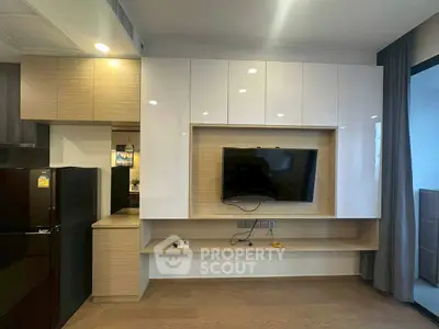 Modern living room with wall-mounted TV and sleek cabinetry