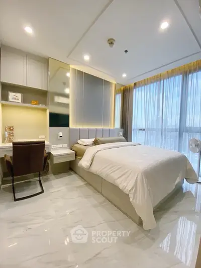Luxurious modern bedroom with elegant decor and large windows offering stunning views.