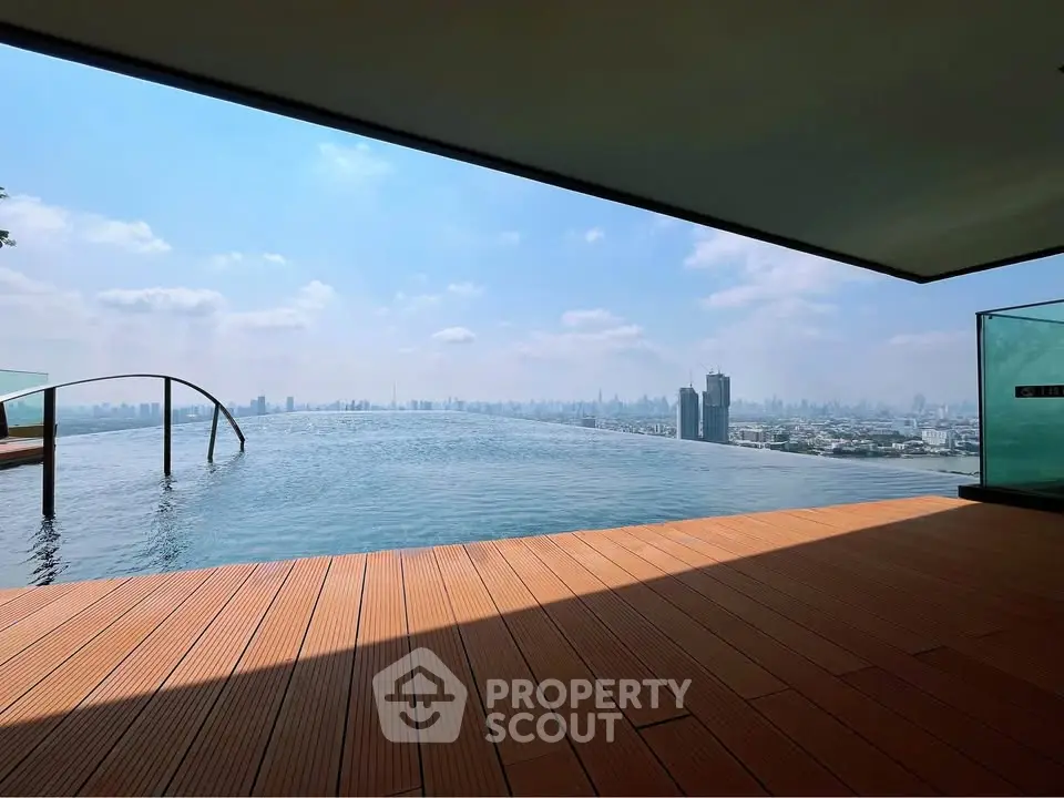 Luxurious rooftop infinity pool with stunning city skyline view, perfect for relaxation and leisure.
