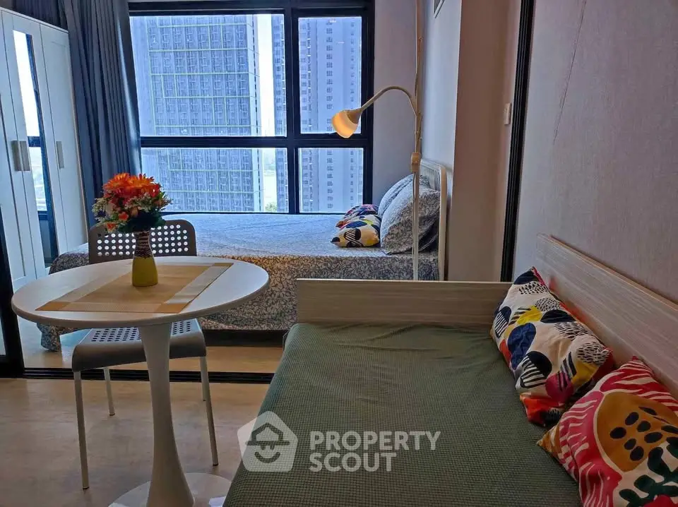 Modern studio apartment with cozy living area and city view