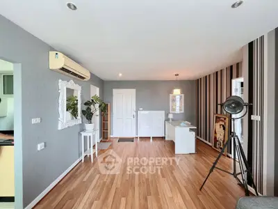 Spacious modern living room with stylish decor and wooden flooring