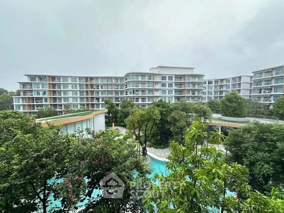 Modern residential building with lush greenery and pool view
