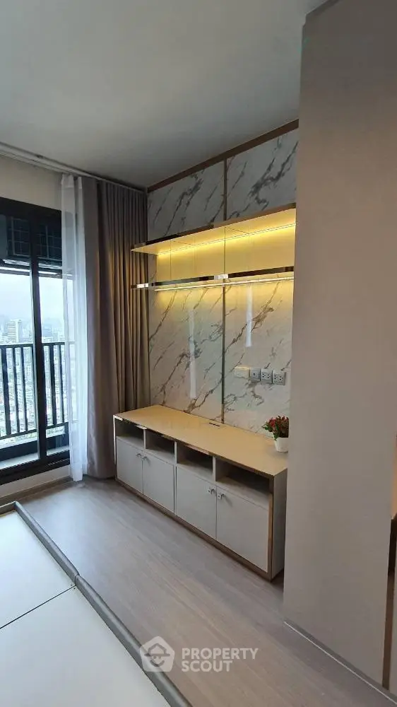 Modern living room with stylish marble wall and balcony view