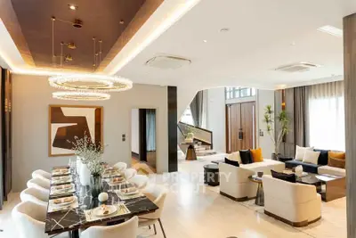 Luxurious open-plan living and dining area with modern decor and elegant lighting.