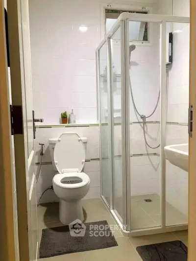 Compact bathroom with shower and toilet in modern apartment