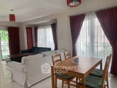 Spacious living room with elegant curtains and cozy seating area