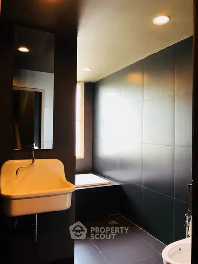 Modern bathroom with sleek black tiles and stylish fixtures