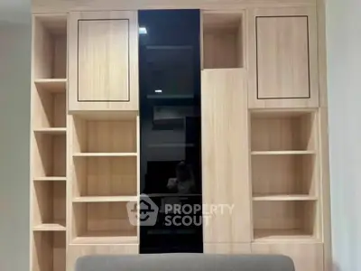 Modern built-in wooden storage unit with sleek design and ample shelving space.