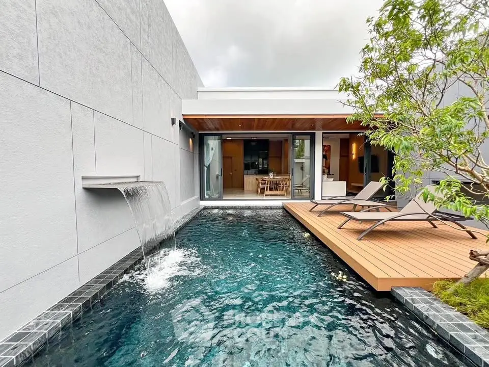 Luxurious modern home with private pool and wooden deck, perfect for relaxation and entertaining.