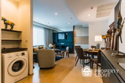 Modern open-plan living room with stylish decor and washing machine in corner