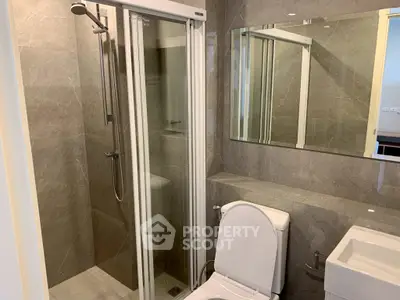 Modern bathroom with glass shower and sleek fixtures