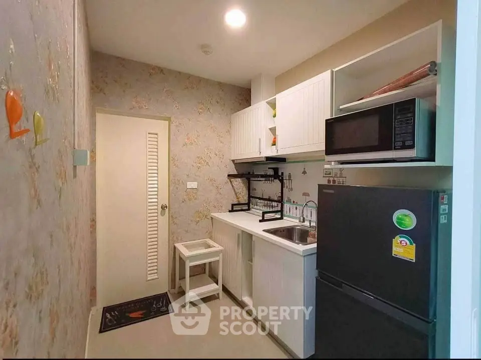 Charming compact kitchen with modern appliances and stylish decor, perfect for cozy urban living.