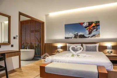 Luxurious bedroom with modern decor and elegant bathtub in a stylish hotel suite.