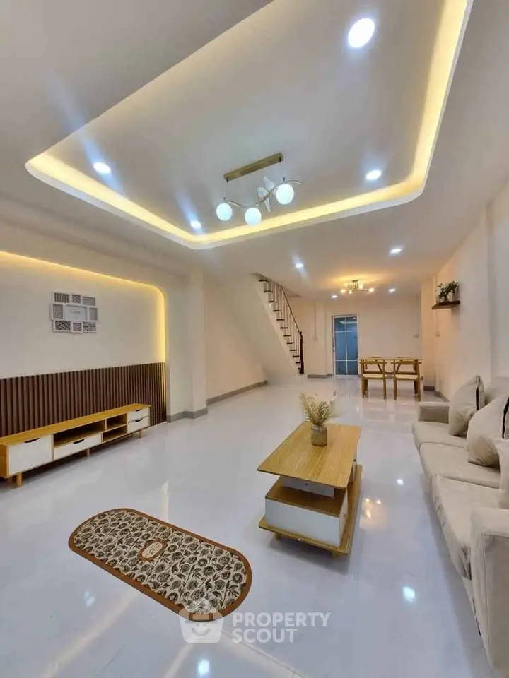 Spacious modern living room with stylish ceiling lights and elegant decor