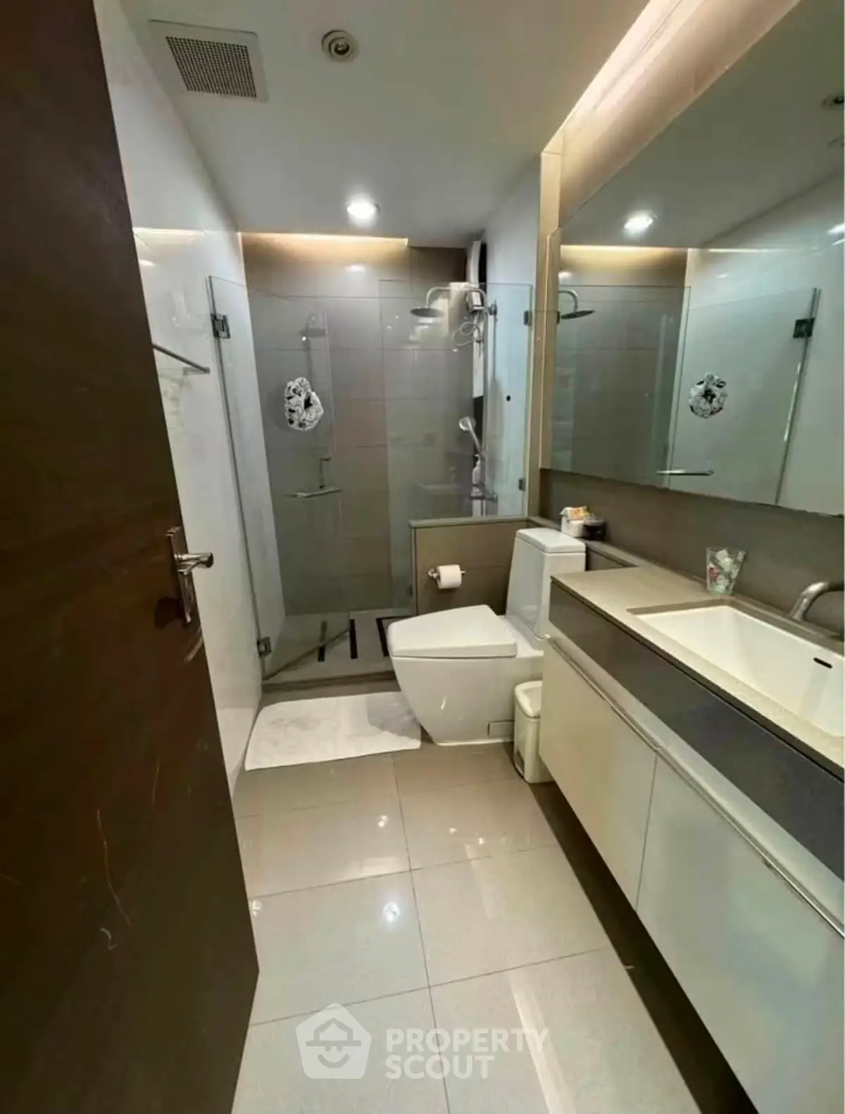Modern bathroom with sleek fixtures and glass shower enclosure