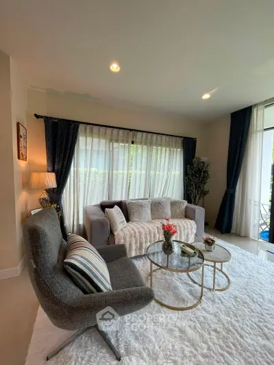 Elegant living room with plush seating and natural light, perfect for relaxation and entertaining.