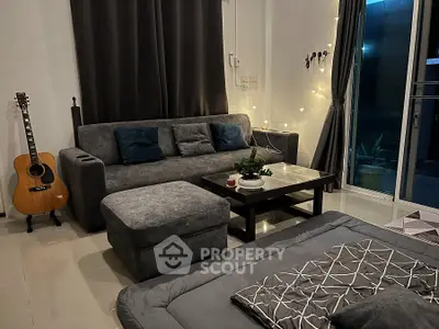 Cozy living room with modern gray sofa and guitar accent