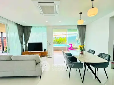 Modern living room with elegant dining area and pool view, featuring stylish furniture and natural light.