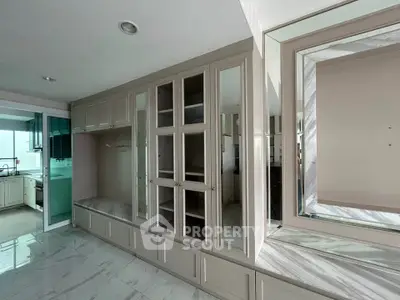 Spacious kitchen with elegant cabinetry and marble flooring, perfect for modern living.