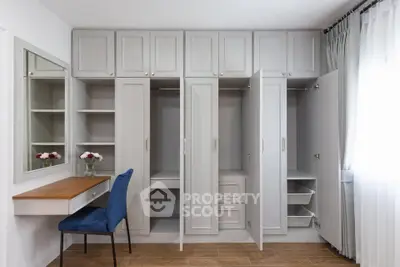 Spacious bedroom with built-in wardrobe and elegant vanity desk