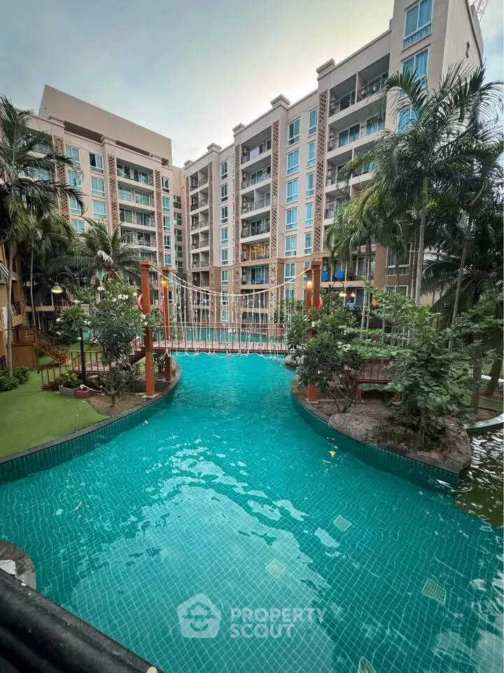 Luxurious condominium with stunning pool and lush greenery, perfect for resort-style living.