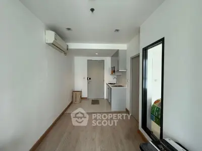 Modern apartment interior with open kitchen and air conditioning, featuring sleek design and ample natural light.