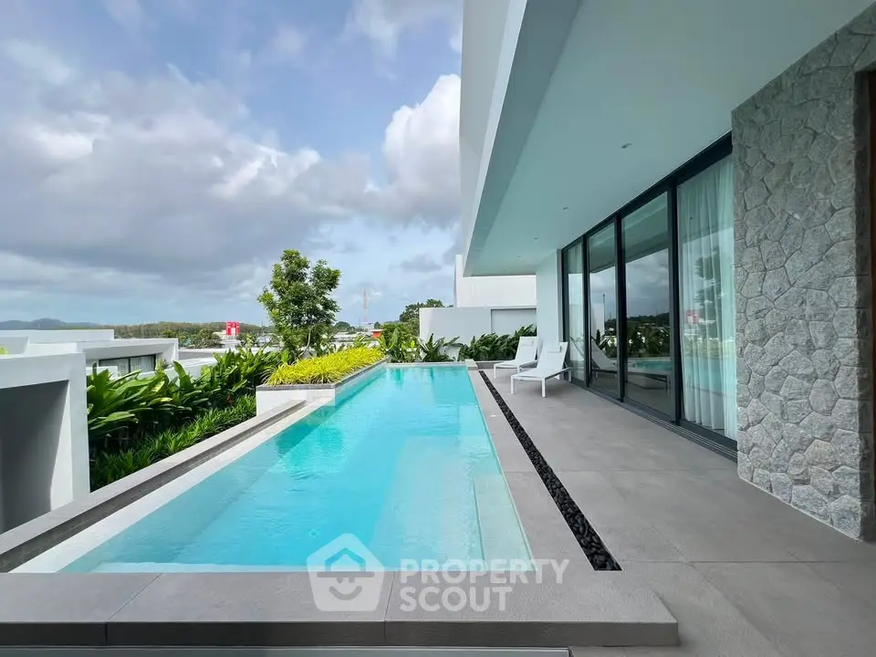 Luxurious modern villa with private pool and lush greenery, perfect for relaxation and leisure.