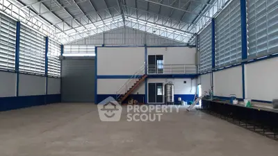 Spacious industrial warehouse with high ceilings and mezzanine office space.