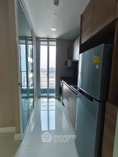 Modern kitchen with sleek appliances and large windows offering city views