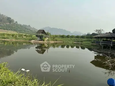 Scenic lakeside view with rustic cabins and lush greenery, perfect for tranquil living.