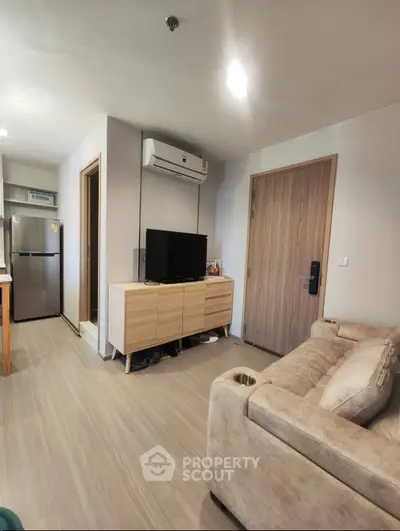 Modern living room with cozy sofa, TV, and air conditioning in a stylish apartment.