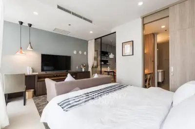 Modern bedroom with stylish decor, open layout, and cozy ambiance in a contemporary apartment.