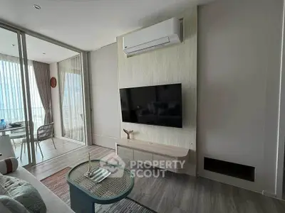 Modern living room with sleek TV setup and balcony view